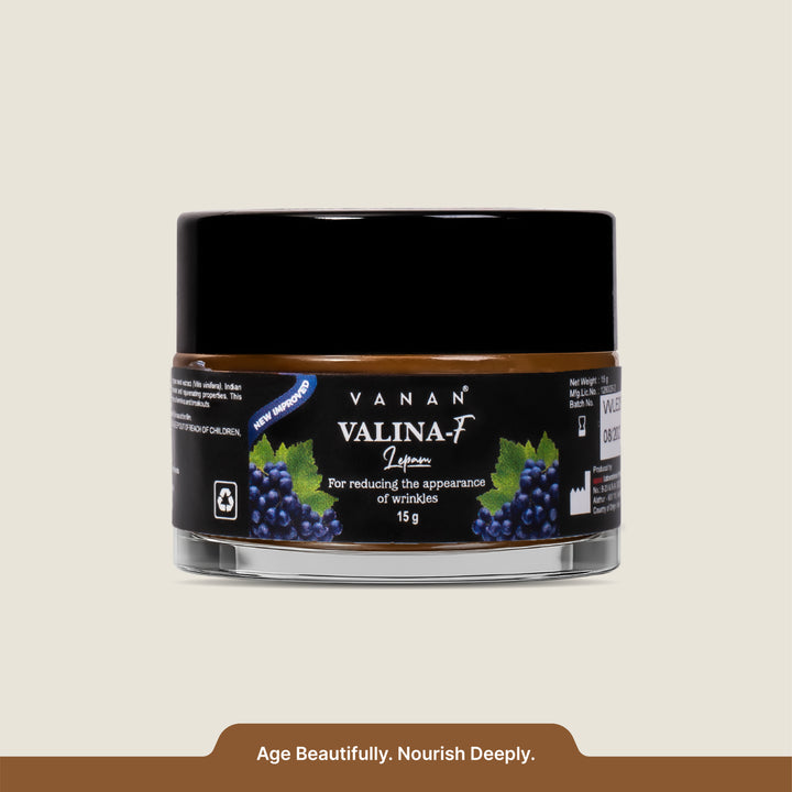 Jar of Vanan Valina-F cream with black lid and blue label on a beige background