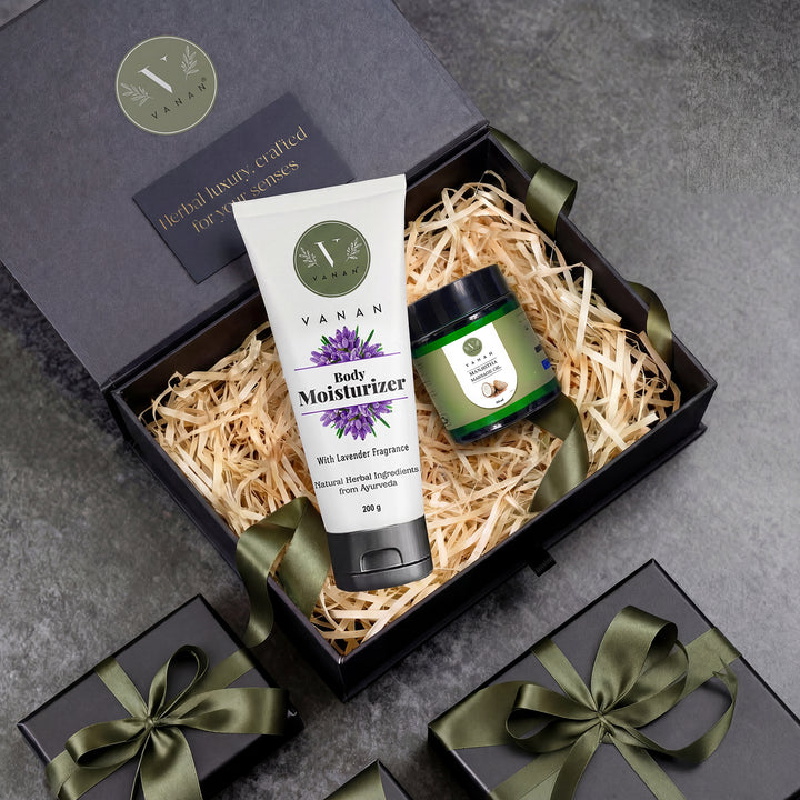 Vanan body moisturizer and jar in a gift box with green ribbons on a gray surface