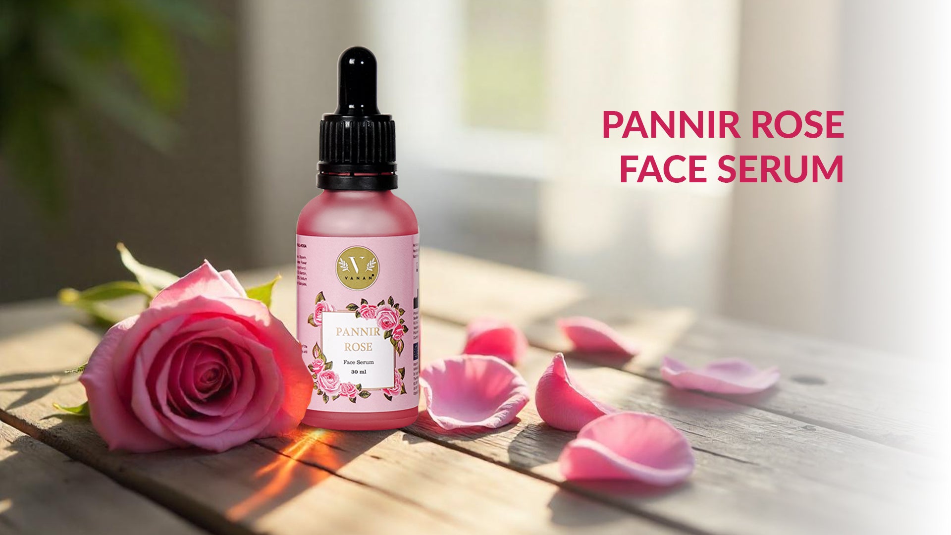 Pannir Rose Face Serum bottle with a pink rose and petals on a wooden surface