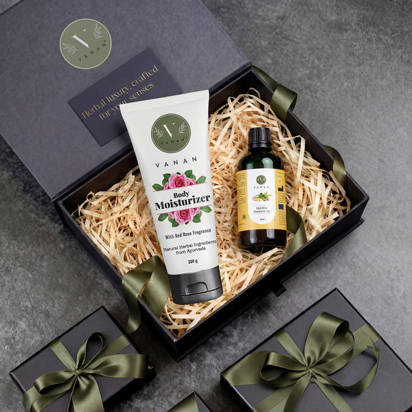 Gift set with Vanan body moisturizer and oil in a decorative box on a gray surface