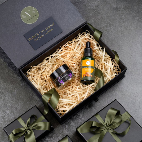 Gift set with a bottle and jar in a decorative box on a gray surface
