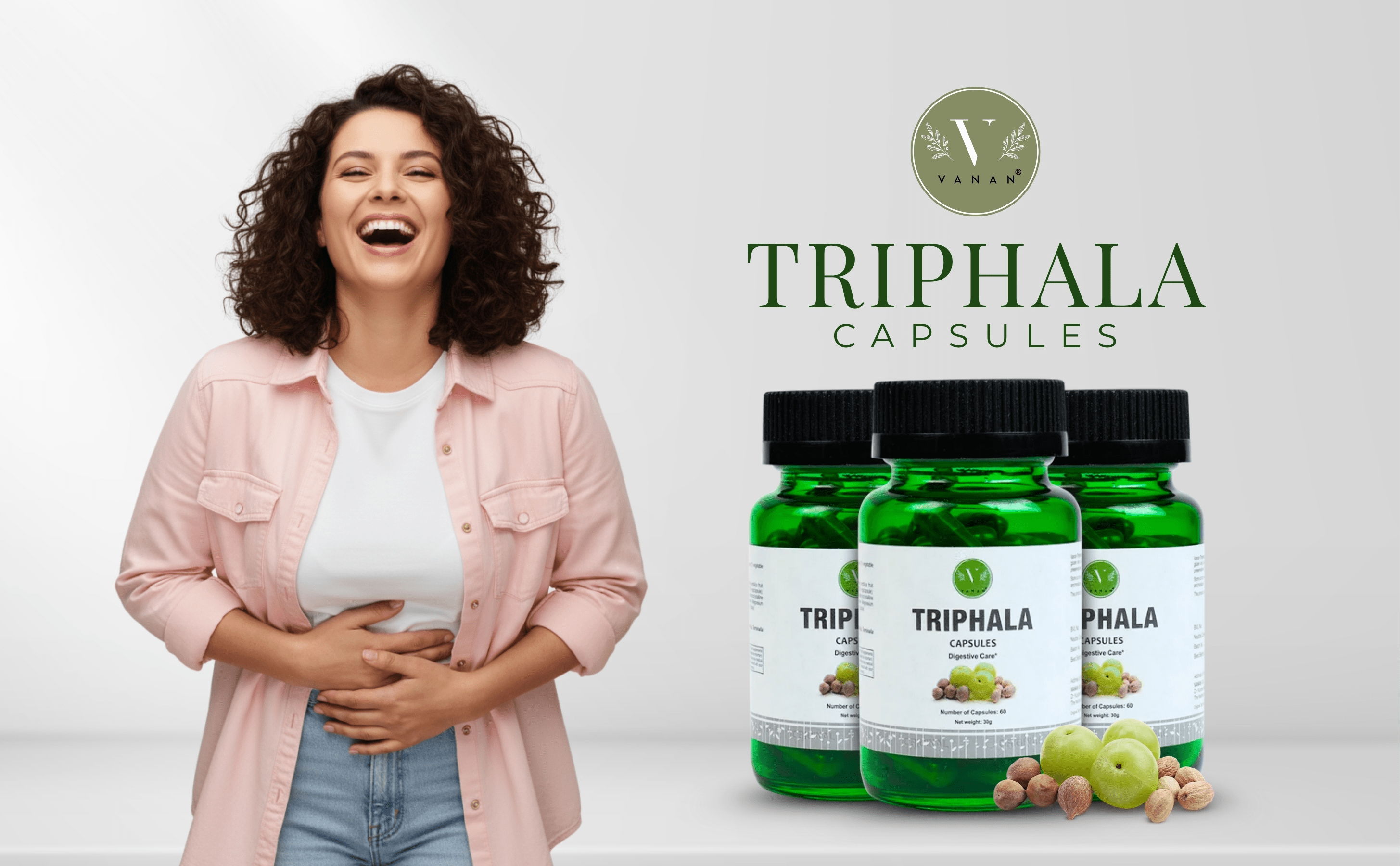 Woman with a happy expression next to Triphala capsules on a white background
