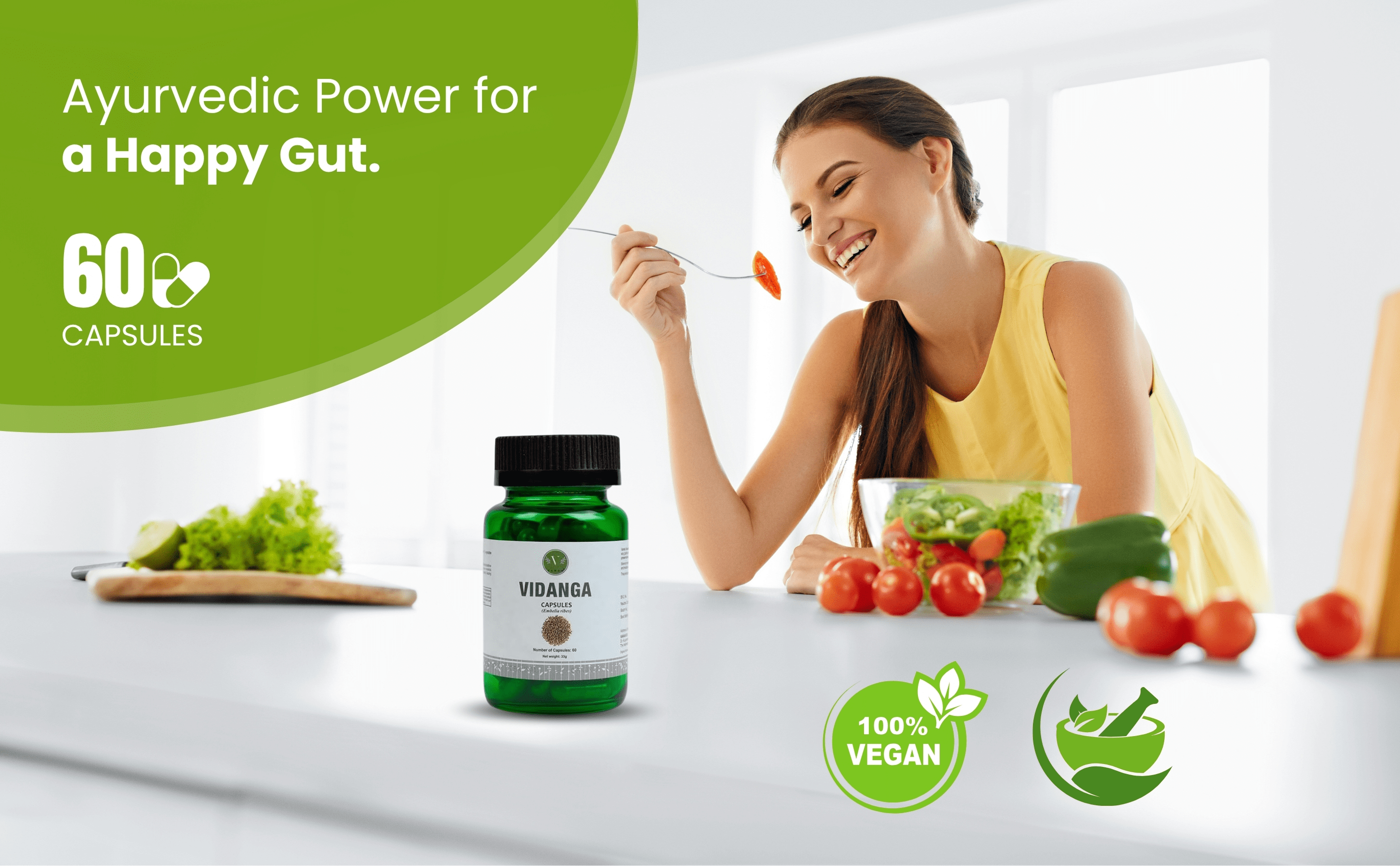 Woman eating vegetables with a bottle of Vidanga capsules on a table, surrounded by healthy food items.